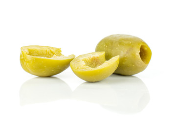 Group of one whole two halves of pitted green olive isolated on white background