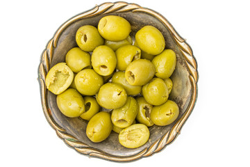 Lot of whole pitted green olive in old iron bowl flatlay isolated on white background