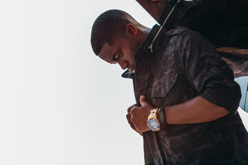 Side view of man adjusting jacket