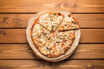 Pizza on wooden background. Top view