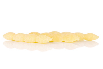 Group of three whole uncooked pasta cavatelli in row isolated on white background