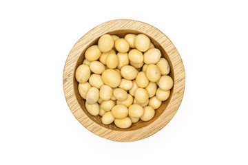 Lot of whole raw yellow soya bean in wooden bowl flatlay isolated on white background