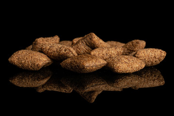 Lot of whole crispy brown cereal pillow isolated on black glass