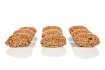 Group of nine whole crispy brown cereal pillow isolated on white background