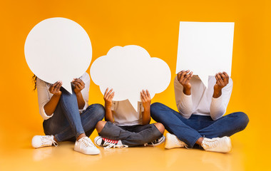 Empty speech bubbles in hands of african american family