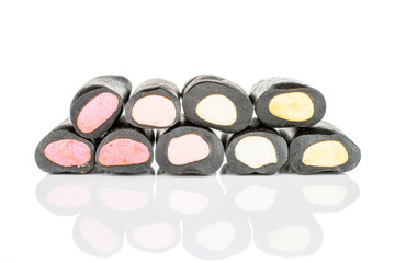 Group of nine whole sweet black liquorice candy isolated on white background