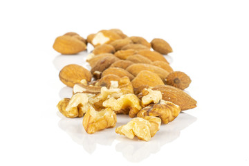 Lot of whole brown almond nut isolated on white background