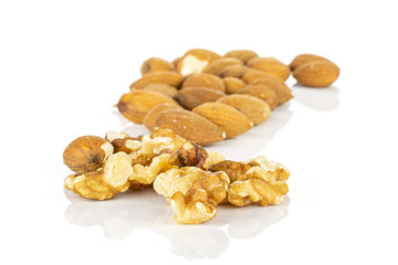 Lot of whole brown almond nut heap isolated on white background