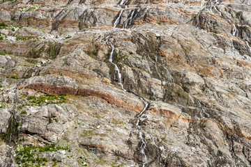 Streams running down canyon mountain side sediments and rocks