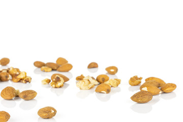 Lot of whole brown almond nut heap isolated on white background