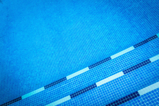 Blue gresite pool bottom. Summer, water sports and relax concept.