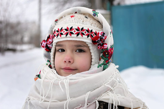 Happy kids in traditional Ukrainian dresses during Christmas holidays