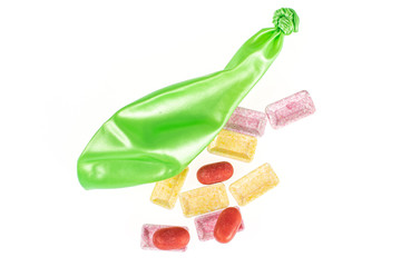 One whole latex pastel ballon with pastel candies flatlay isolated on white background
