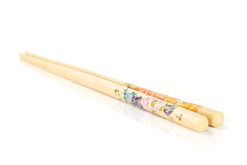 Group of two whole asian brown chopsticks isolated on white background