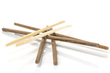 Group of four whole asian brown chopsticks stack isolated on white background