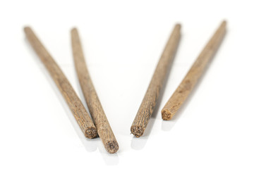 Group of four whole dark asian brown chopsticks isolated on white background