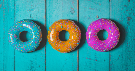 colorful donuts assorted donuts with chocolate frosted, pink glazed and sprinkles donuts 