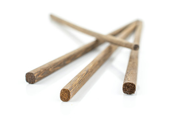 Group of four whole crossed asian brown chopsticks isolated on white background