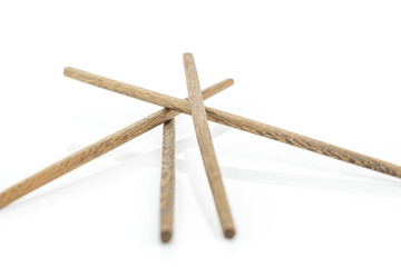 Group of four whole dark asian brown chopsticks isolated on white background