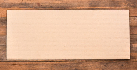 blank corrugated paper on grunge wooden table