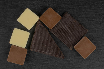 Lot of whole fresh chocolate piece flatlay on grey stone