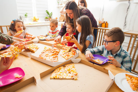 Children Eating Pizza On The Kids Party