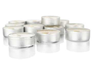 Lot of whole waxy white tea candle heap isolated on white background