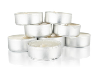 Lot of whole waxy white tea candle stack isolated on white background