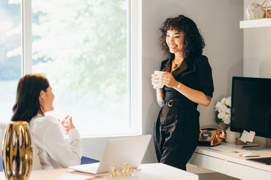 Close Up View Of Two Businesswomen Chatting In Office