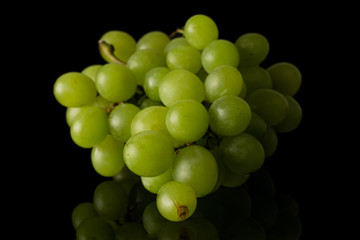 Lot of whole fresh green grape isolated on black glass