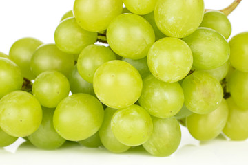 Plakat Lot of whole fresh green grape cluster closeup isolated on white background