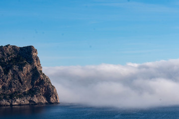 Fototapeta na wymiar Rock with Budda silhouette on sea