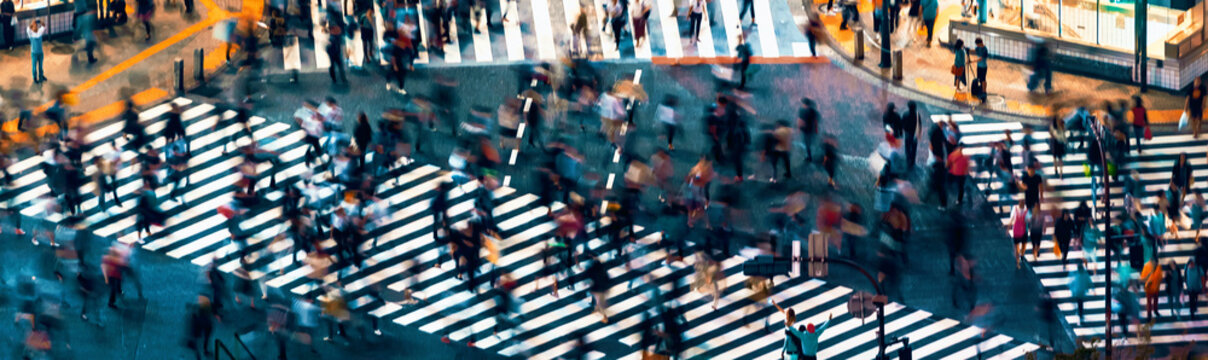 Pedestrians Cross The Shibuya Scramble Crosswalk In Tokyo, Japan, One Of The Busiest Intersections In The World