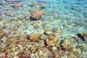 Fototapeta na wymiar Pebbles underwater on the seabed in Kokkari on the island of Samos in Greece.
