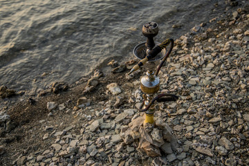 hookah on stone lake shore line outdoor environment, relaxation life style object picture 