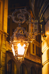 Old vintage metal lanterns or street lamps on building of Opera de Nice at night