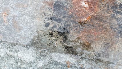 Background. Old gray metal wall with weathered paint, scratches and rust.