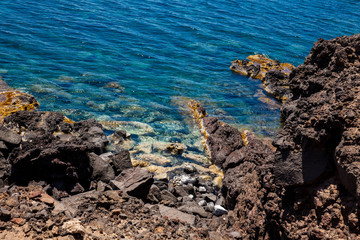 Detail of the rocks on the famous Red Beach at Santorini Island in a beautiful early spring day