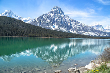 Snowy mountain reflected in turquoise lake
