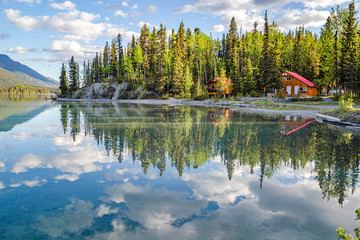 Pines and sky reflected in Muncho Lake