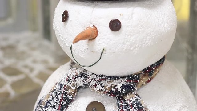 Artificial snowman in a photo studio close up