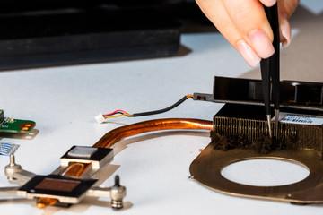 Woman engineer cleaning cooling system from dust