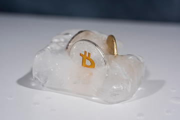 Abstract photo of cryptocurrency. Frozen coins in ice.
