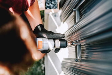 Industrial details of working construction man, using screwdriver