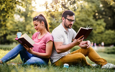 Student's love. Young couple learning together in the park. Education, love and tenderness, dating, romance, lifestyle concept
