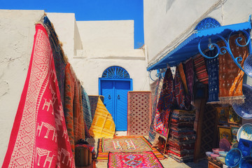 Shop selling carpets, Souvenirs and fabrics in the Bazaar in the Medina, Sidi Bou Said, Tunisia....