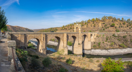 Fototapeta na wymiar The Roman bridge of Alcantara is a two thousand year old stone bridge that crosses the Tagus River. Built by the Romans to connect an important commercial route.