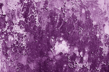 Grungy rusted metal wall surface in purple tone.