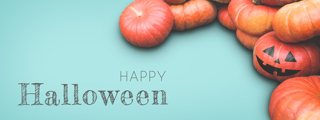 Blue Halloween banner with many pumpkins and jack o lantern.