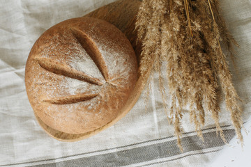 Loaf of bread on a board on a white tablecloth